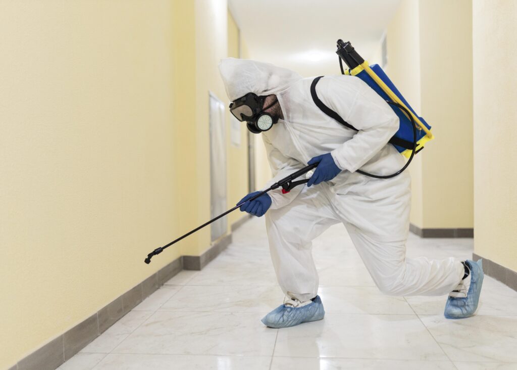 full shot man disinfecting building full shot man disinfecting building